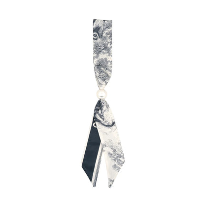a grey and off white toile scarf with pearl slide. 