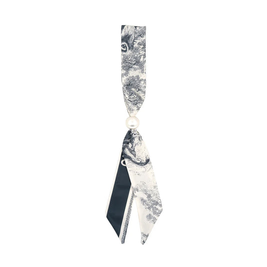 a grey and off white toile scarf with pearl slide. 