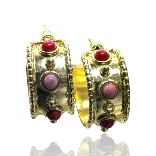 Gold hoop earrings with pink and coral stones on a white background