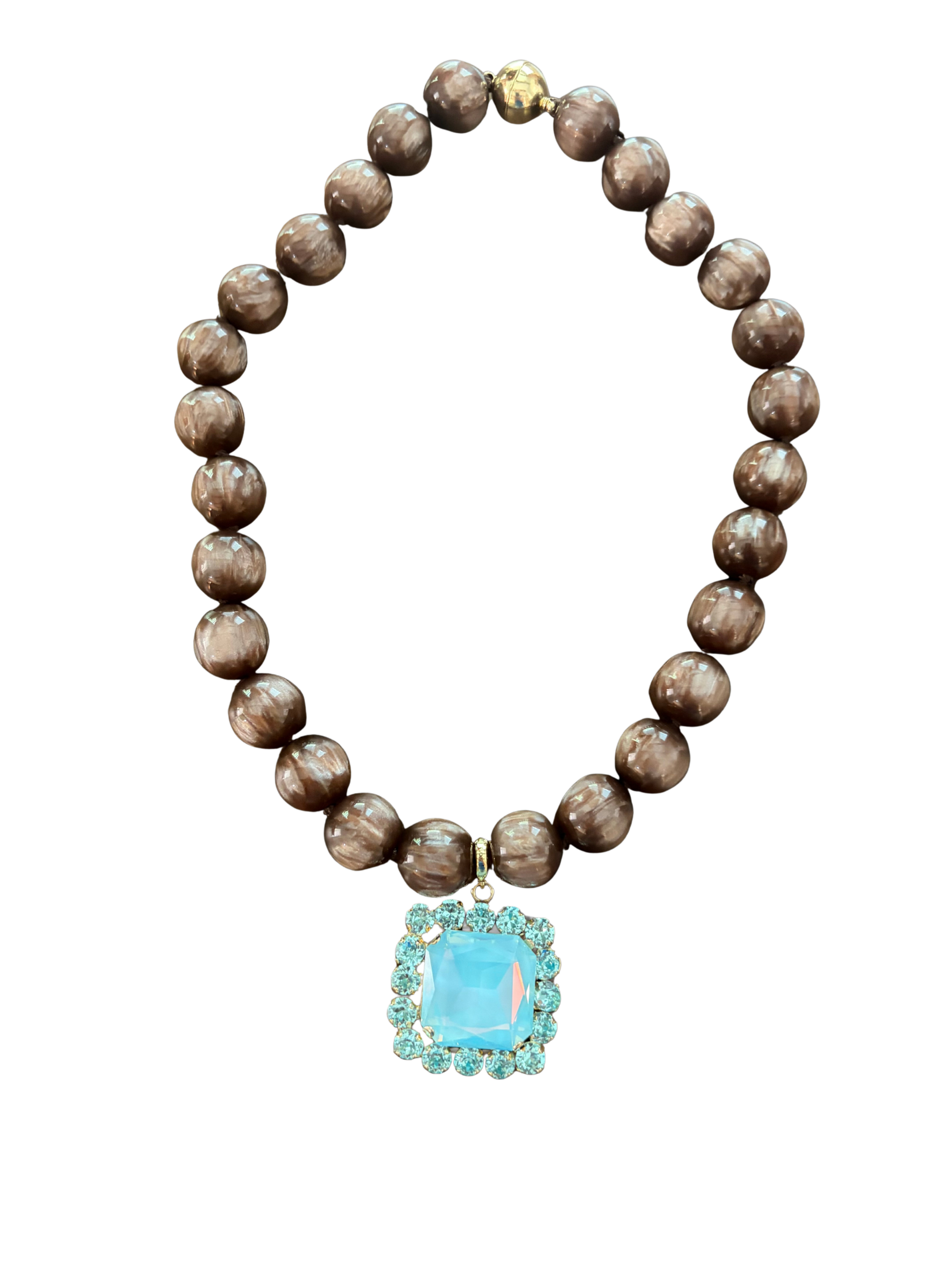 a beaded brown swirl magnetic necklace with a pale blue crystal pendant removeable charm. 
