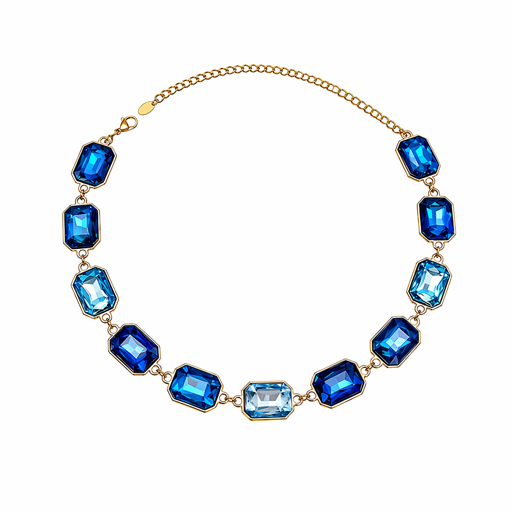 A gold chain necklace featuring multiple rectangular blue gemstones in varying shades, with one larger light blue stone at the center, displayed on a clean white background.