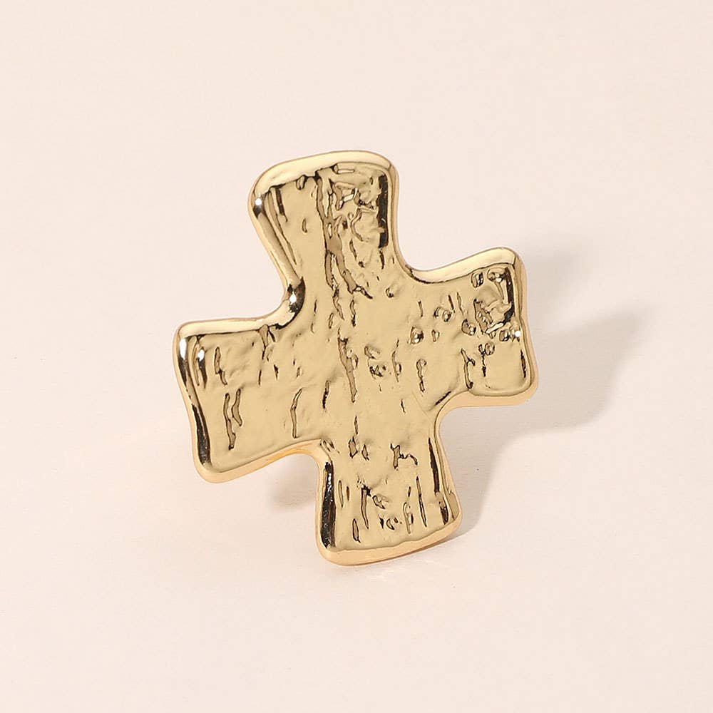 A textured gold cross-shaped ring with a hammered finish