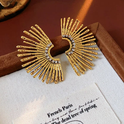 Gold sunburst earrings with rhinestones