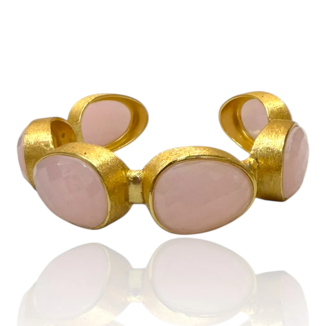 Gold and pink stone bracelet on a white background