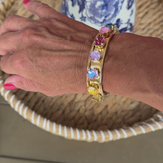 video of gold cuff with colored crystals
