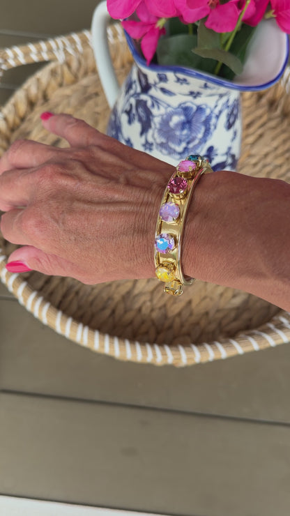 video of gold cuff with colored crystals