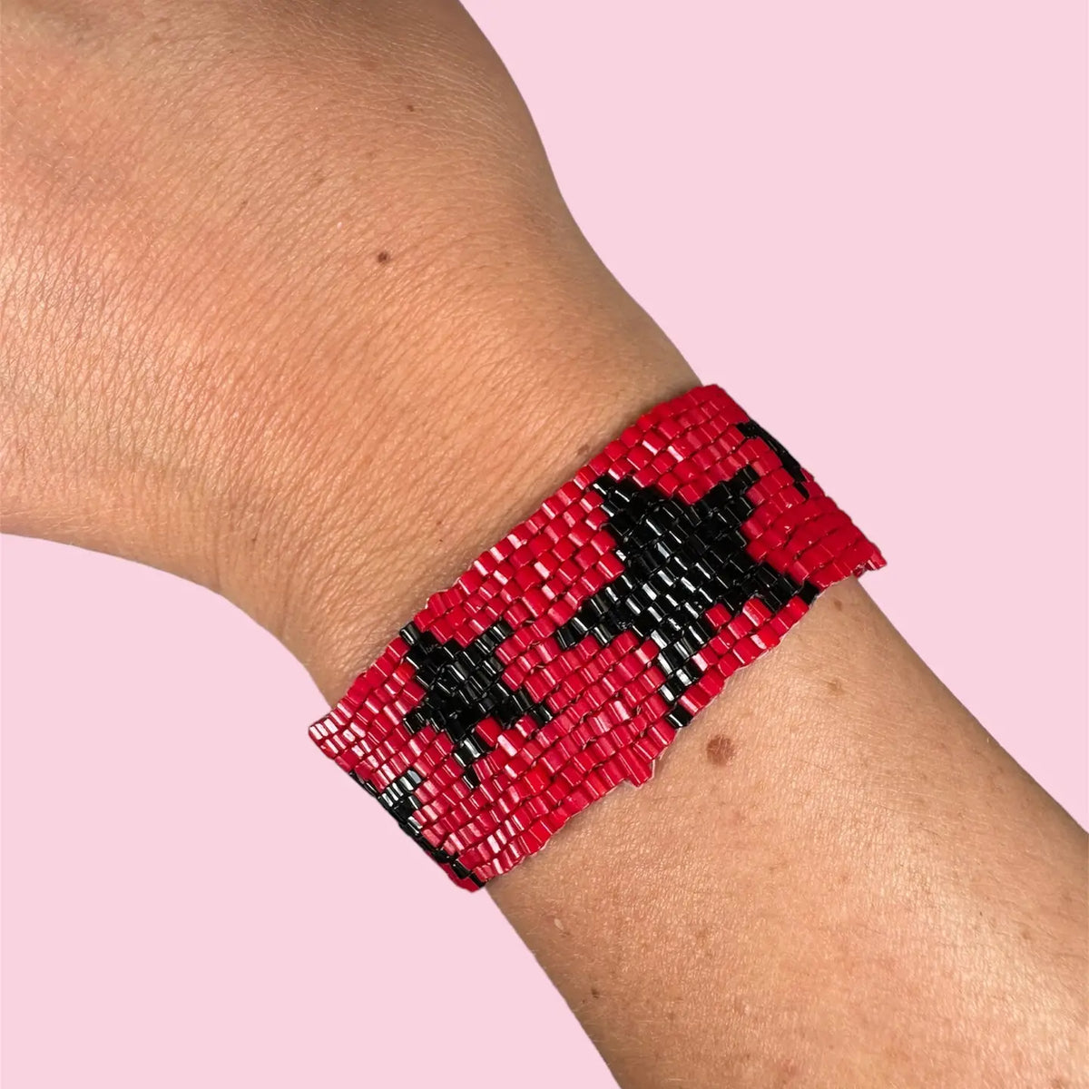A red and black beaded cuff bracelet with stars