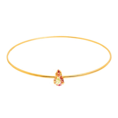 Tova Gold bangle bracelet with a teardrop-shaped blush pink crystal. 