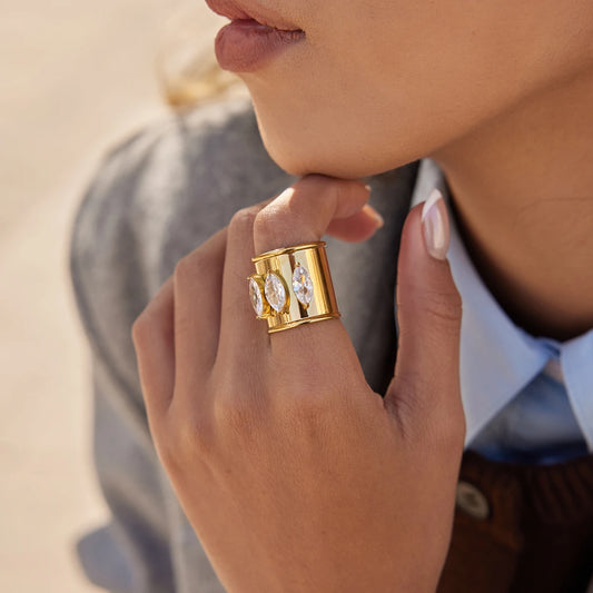 stainless steel ring, gold plated with 3 marquis diamonds on it. Adjustable