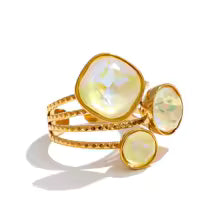 3 stone gold ring with lemon colored crystals
